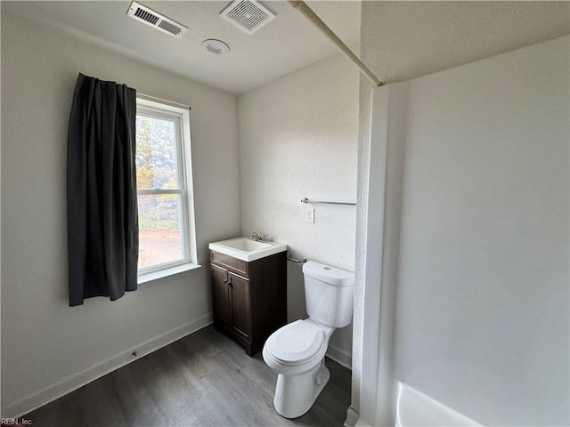 bathroom featuring hardwood / wood-style flooring, vanity, and toilet