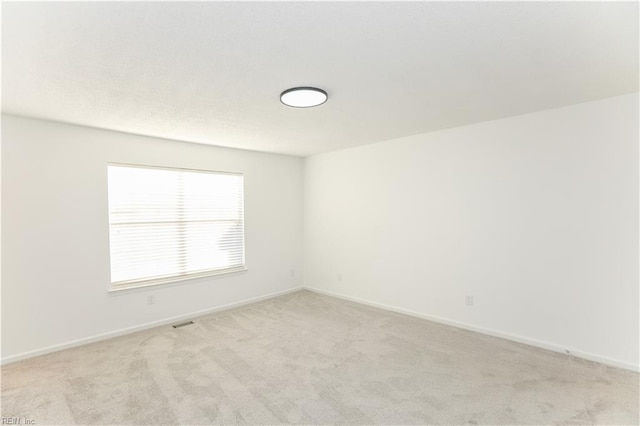 empty room featuring light colored carpet