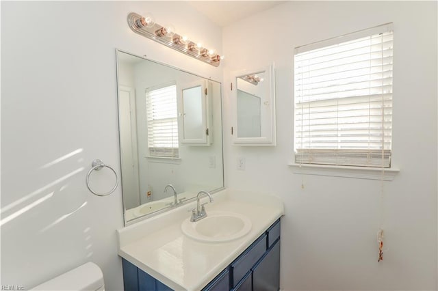 bathroom featuring vanity and toilet