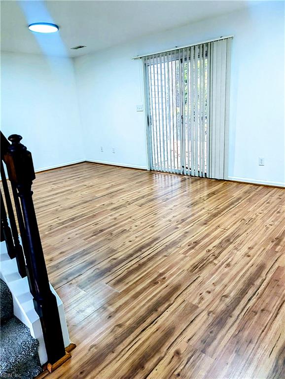 empty room with hardwood / wood-style floors