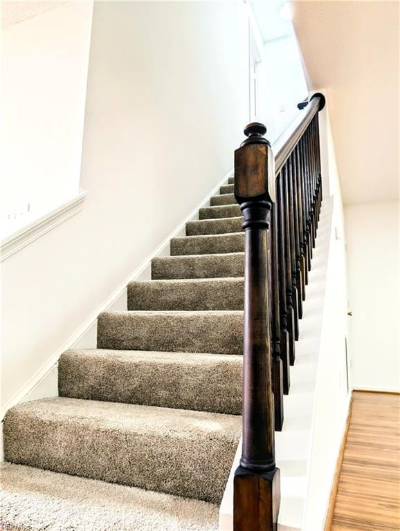 staircase featuring hardwood / wood-style flooring