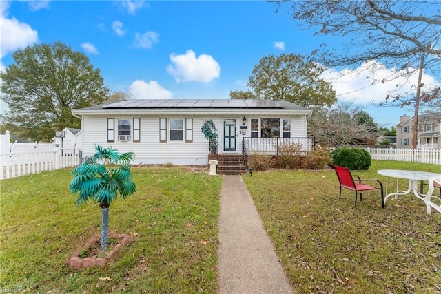 view of front of home with a front yard and solar panels