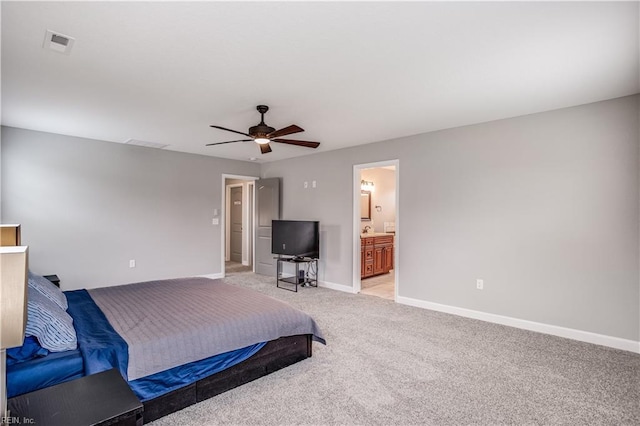 bedroom featuring ensuite bath, ceiling fan, and light carpet