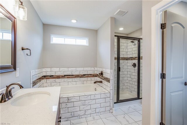 bathroom with plenty of natural light, vanity, and shower with separate bathtub