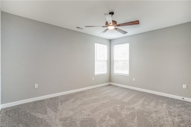 carpeted spare room with ceiling fan