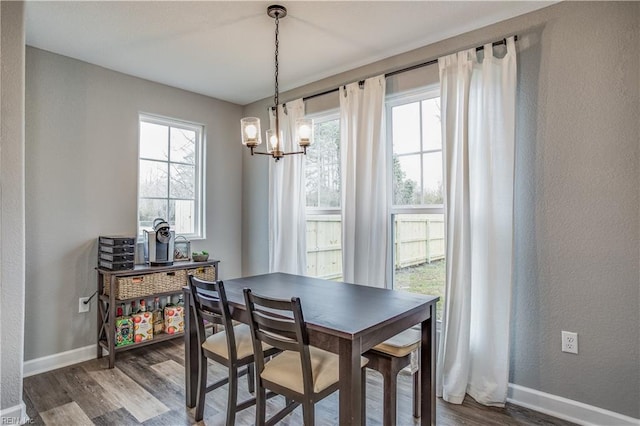 dining area featuring a notable chandelier and dark hardwood / wood-style floors