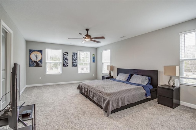 bedroom with ceiling fan and light colored carpet