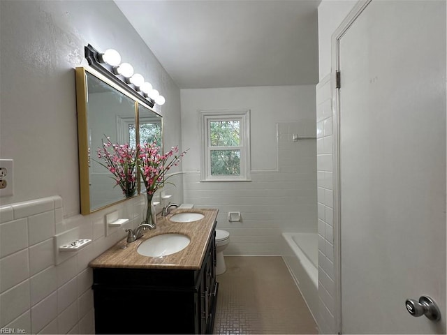 full bathroom with a sink, tile walls, tile patterned floors, and toilet