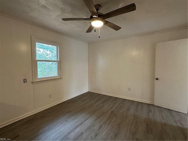 spare room with a ceiling fan, baseboards, dark wood finished floors, and ornamental molding