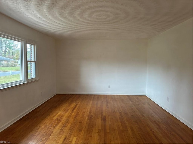 empty room featuring hardwood / wood-style flooring