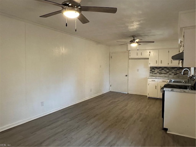 kitchen with a ceiling fan, range hood, dark wood finished floors, a sink, and white cabinets