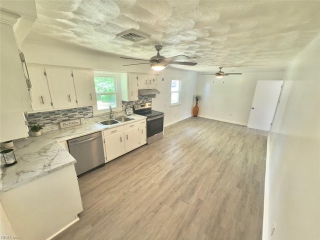 kitchen with a ceiling fan, visible vents, appliances with stainless steel finishes, a sink, and under cabinet range hood