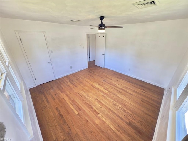 unfurnished bedroom with visible vents, baseboards, ceiling fan, and light wood-type flooring