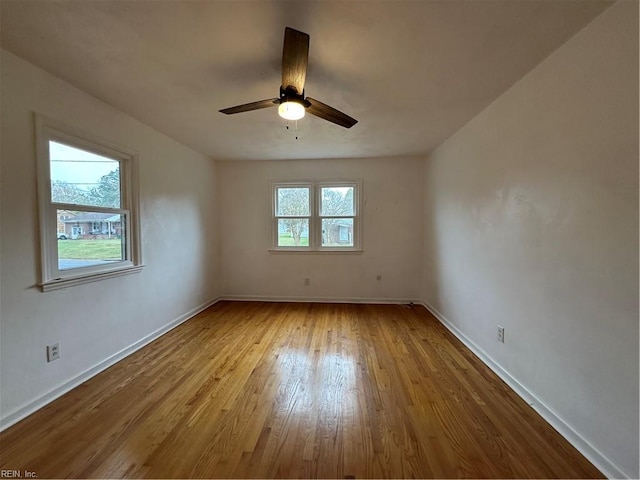 unfurnished room featuring baseboards, ceiling fan, and hardwood / wood-style flooring