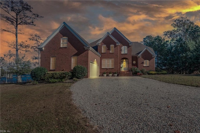 view of property featuring a lawn and a garage