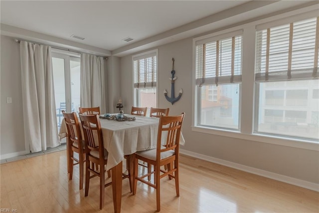 dining space featuring a wealth of natural light and light hardwood / wood-style flooring