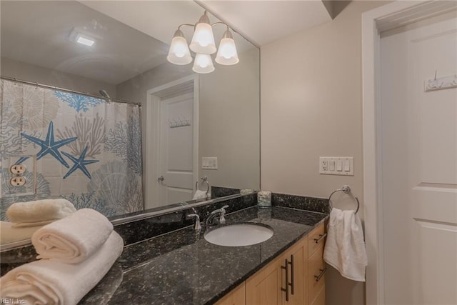 bathroom with a chandelier and vanity