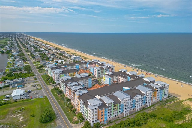 bird's eye view featuring a water view and a beach view