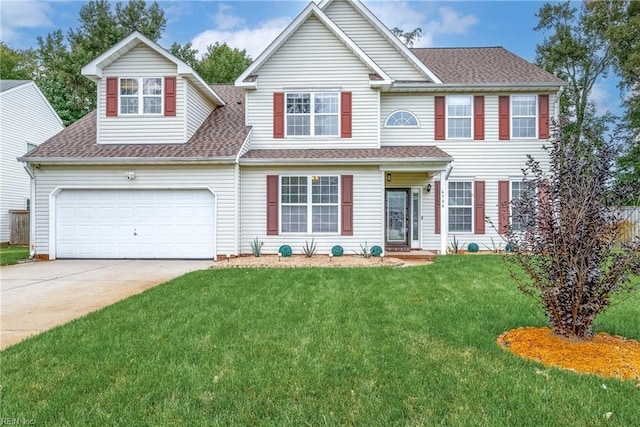 colonial inspired home with a garage and a front lawn