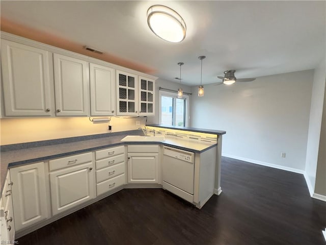 kitchen featuring kitchen peninsula, white dishwasher, white cabinetry, and sink