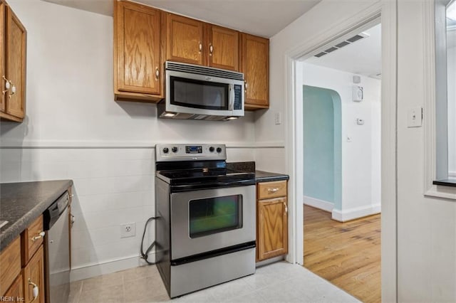 kitchen with appliances with stainless steel finishes and light wood-type flooring