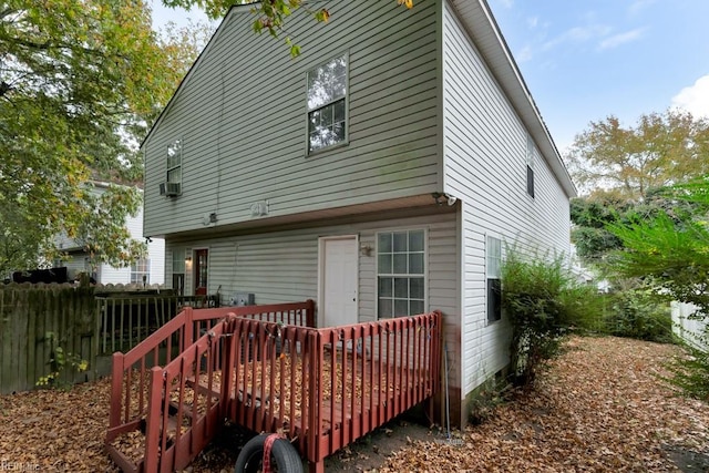 rear view of property featuring a wooden deck