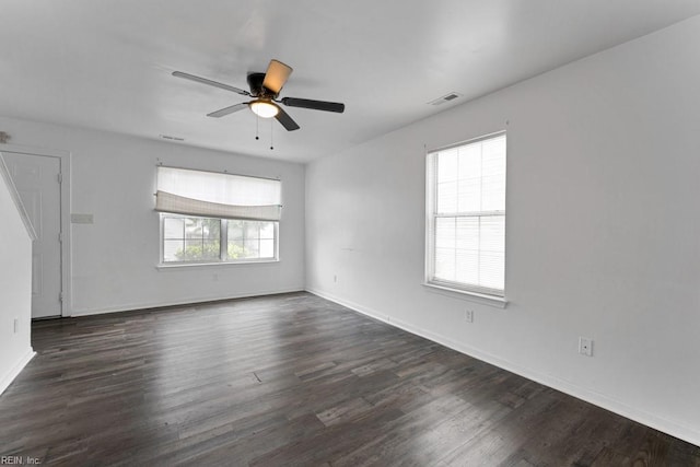 unfurnished room with ceiling fan and dark hardwood / wood-style flooring