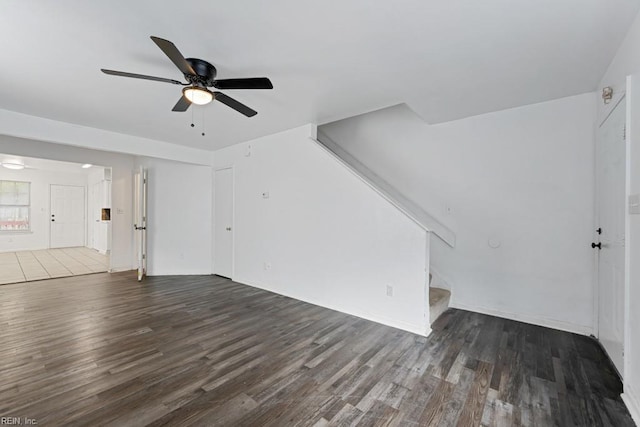 unfurnished living room with ceiling fan and dark hardwood / wood-style flooring