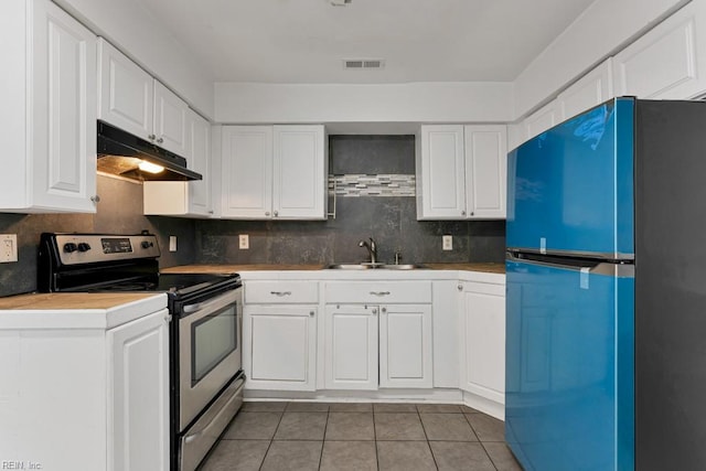 kitchen featuring white cabinetry, sink, refrigerator, and stainless steel electric range