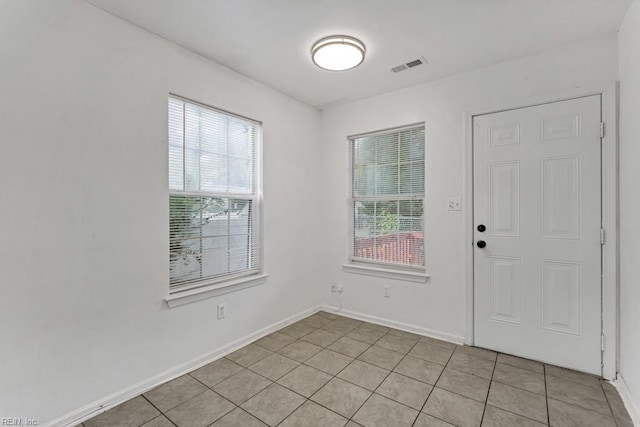 tiled entrance foyer featuring a healthy amount of sunlight