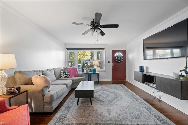 living room with crown molding, ceiling fan, and dark hardwood / wood-style floors