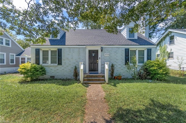 cape cod house with a front yard