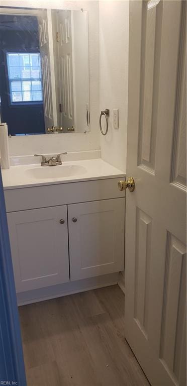 bathroom with vanity and wood-type flooring