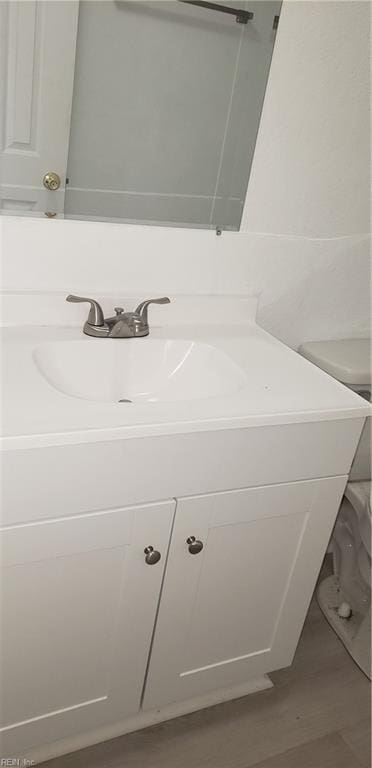 bathroom featuring hardwood / wood-style floors, toilet, and vanity