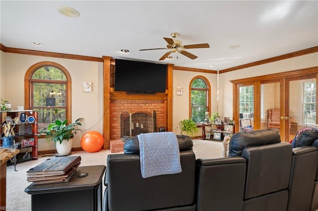 living room with carpet, a healthy amount of sunlight, ornamental molding, and a brick fireplace