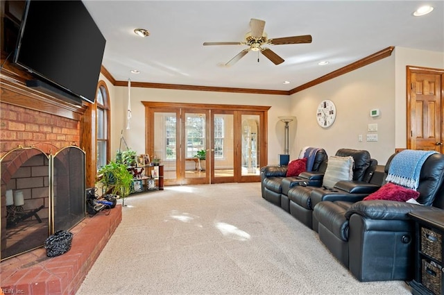 carpeted living room featuring a fireplace, french doors, ceiling fan, and ornamental molding