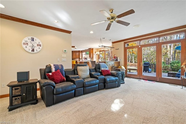 living room with crown molding, light carpet, and ceiling fan with notable chandelier