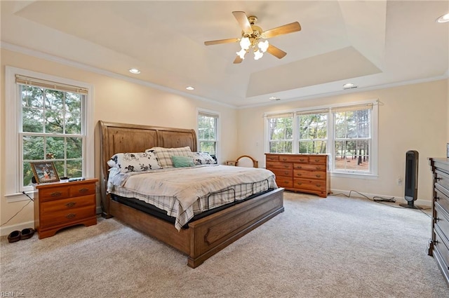 bedroom featuring multiple windows, ceiling fan, and light carpet