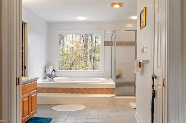 bathroom with tile patterned flooring, vanity, and shower with separate bathtub