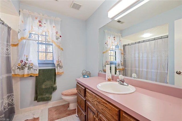 bathroom featuring tile patterned floors, vanity, and toilet