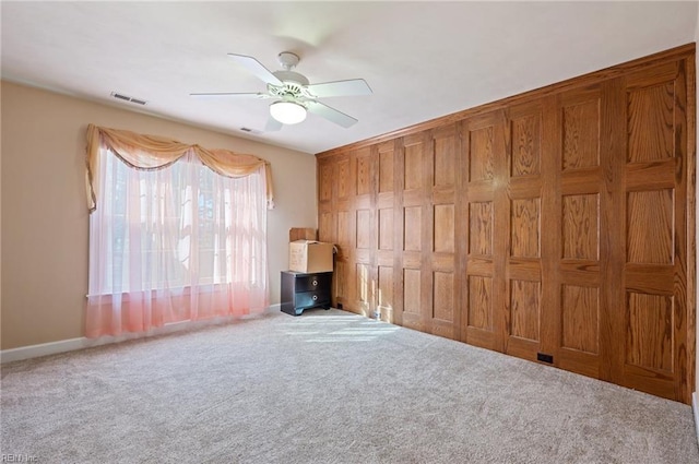 unfurnished living room featuring ceiling fan and carpet floors