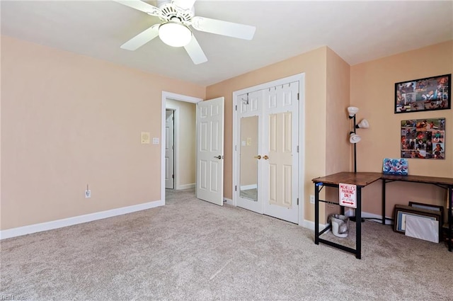 office area featuring ceiling fan and light colored carpet