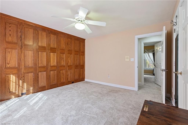 unfurnished bedroom with ceiling fan, light carpet, and a closet