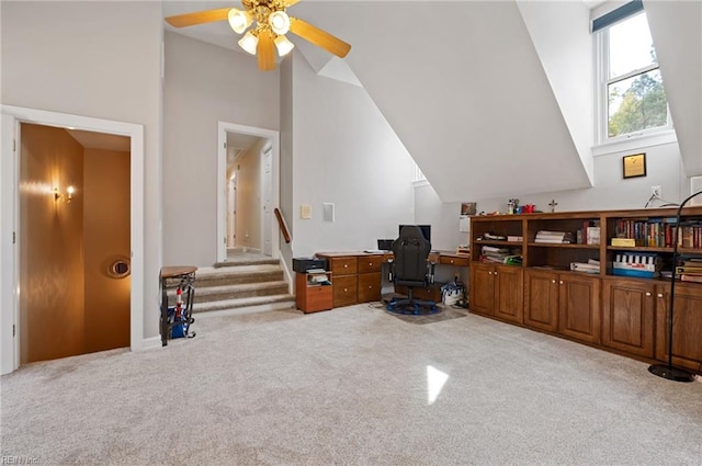 interior space with light carpet, vaulted ceiling, and ceiling fan