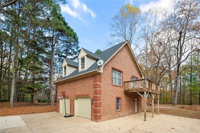 view of side of property with a garage and a wooden deck