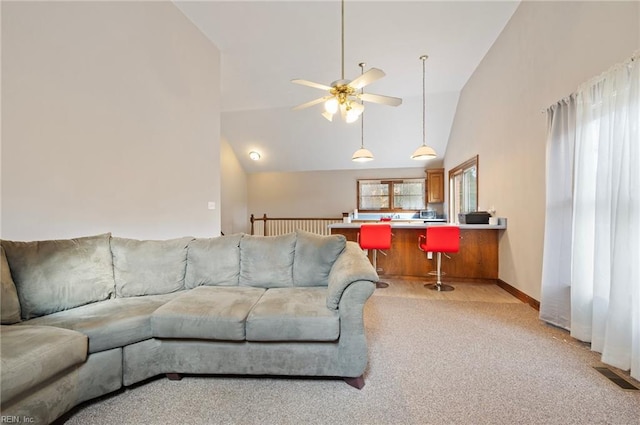 living room featuring light carpet, high vaulted ceiling, and ceiling fan