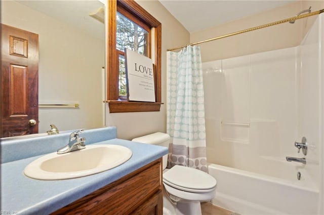 full bathroom with vanity, shower / tub combo, and toilet