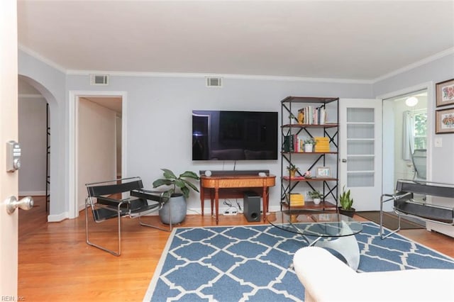 living room featuring hardwood / wood-style floors and ornamental molding