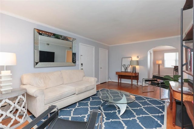 living room with crown molding and hardwood / wood-style floors