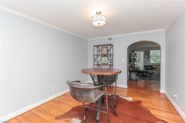 dining room featuring wood-type flooring and ornamental molding